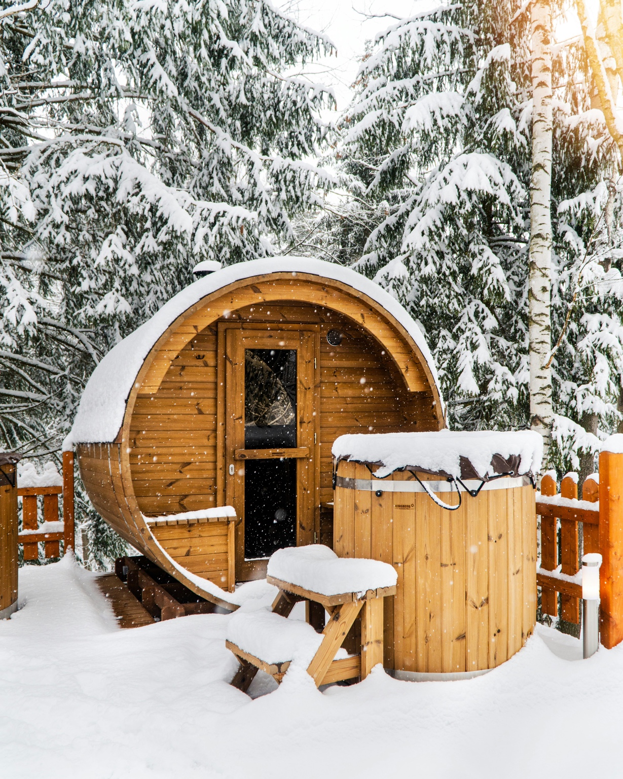 Snow-covered outdoor barrel sauna