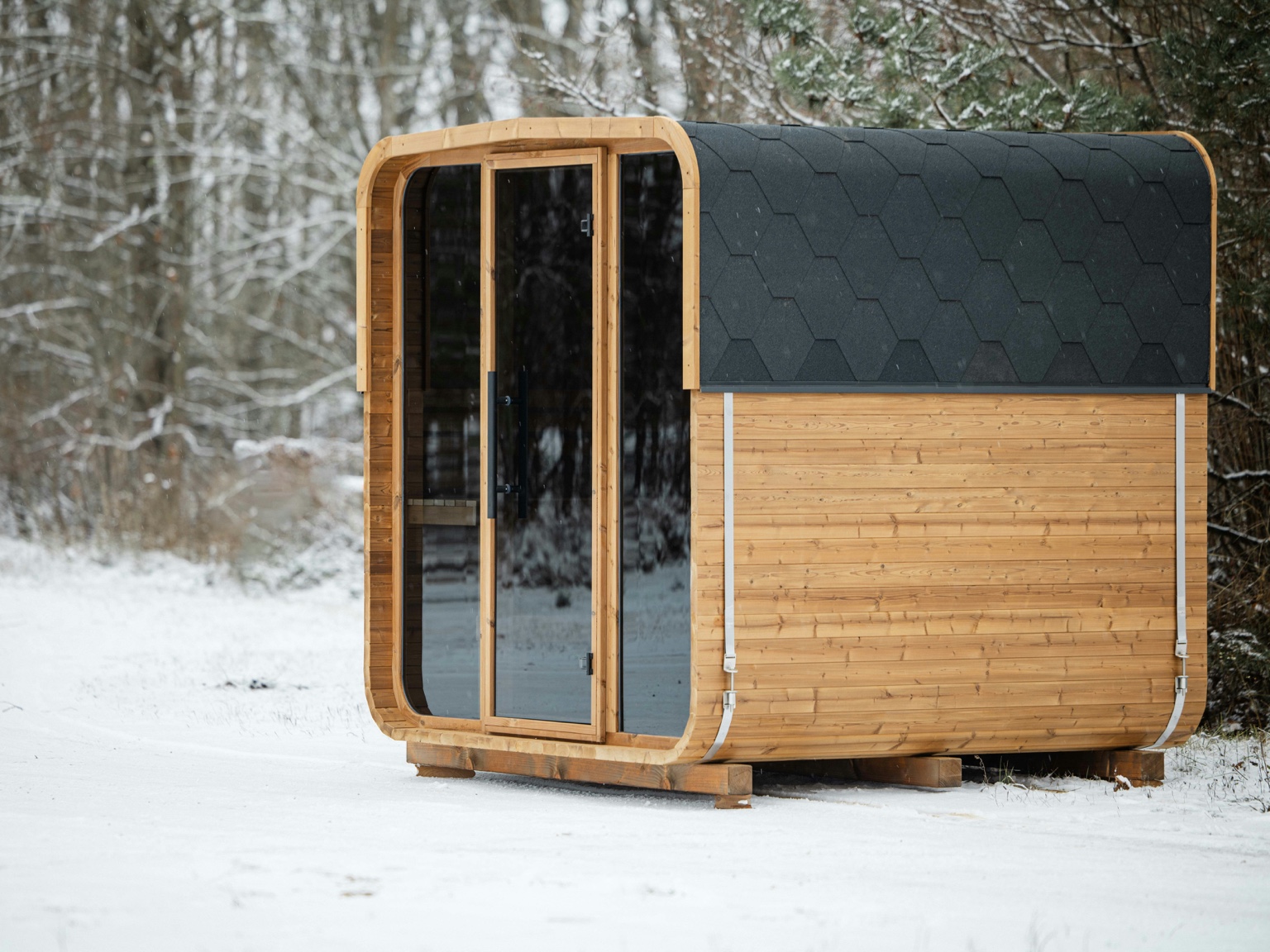 Snow-covered outdoor cabin-style sauna